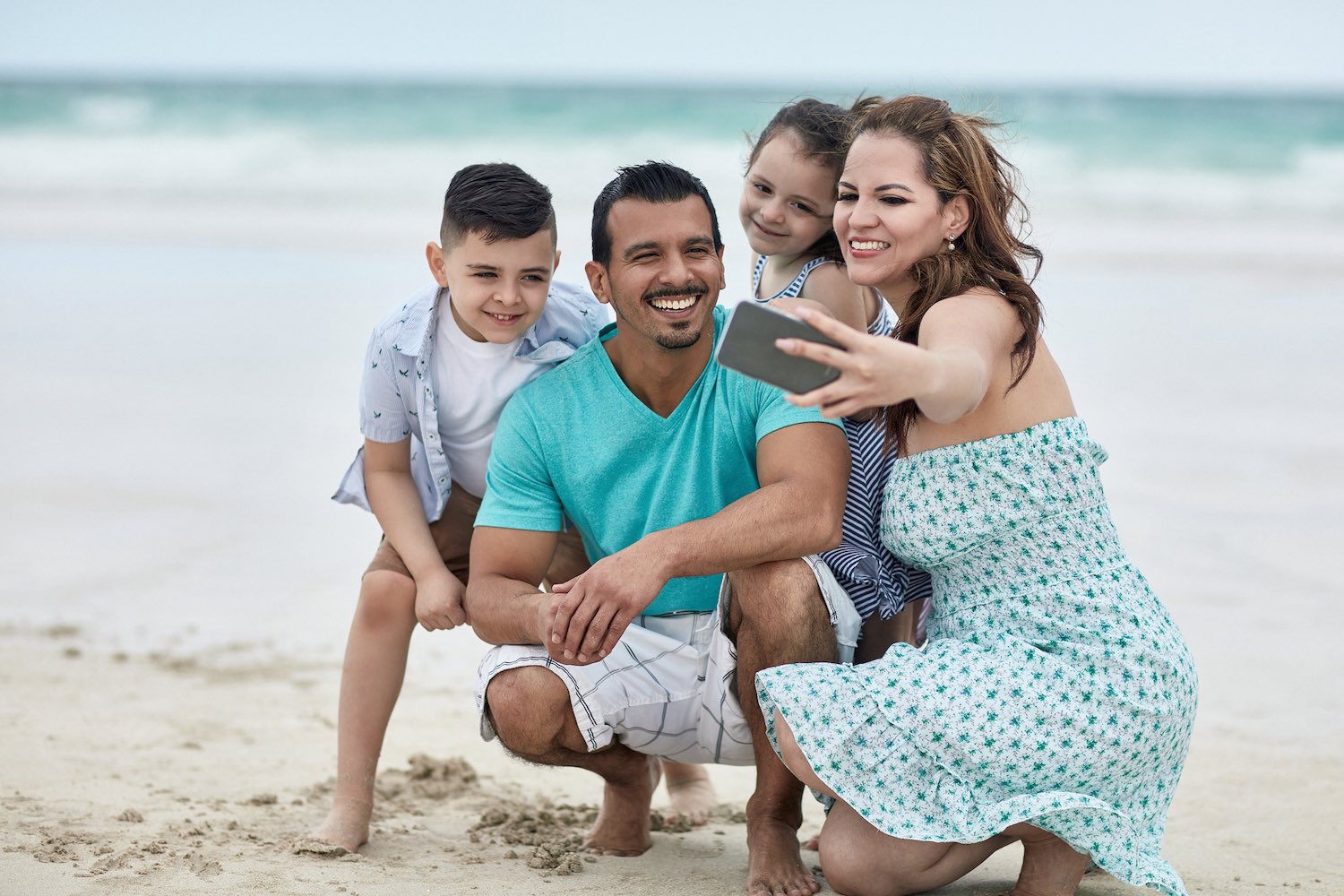 Family Taking A Selfie On A Florida White Sandy Beach